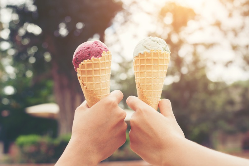 Two people give a "cheers" to the best Leavenworth ice cream shops.