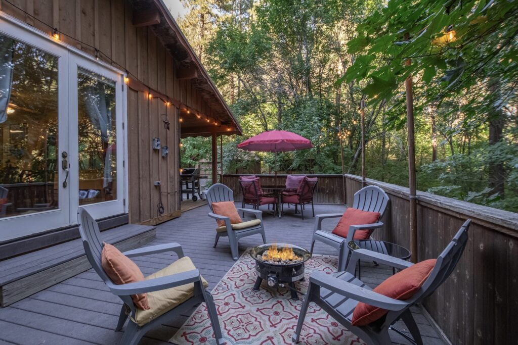 Washington State Vacation Rentals: An inviting deck with four chairs surrounding a propane fire ring.