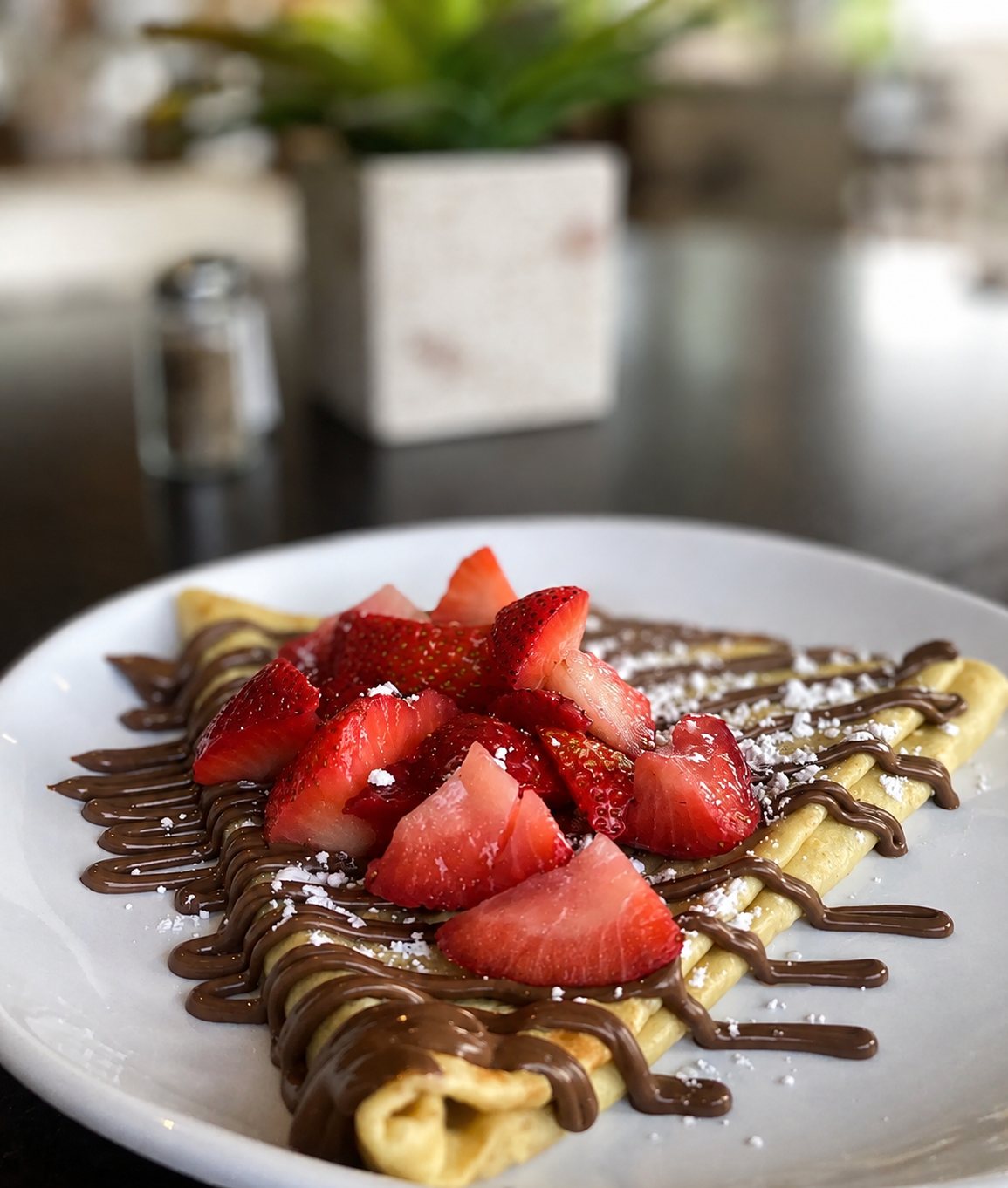 Crepes topped with strawberries and chocolate