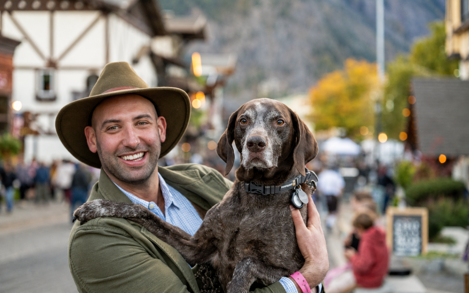 A guest holding his dog in downtown Leavenworth