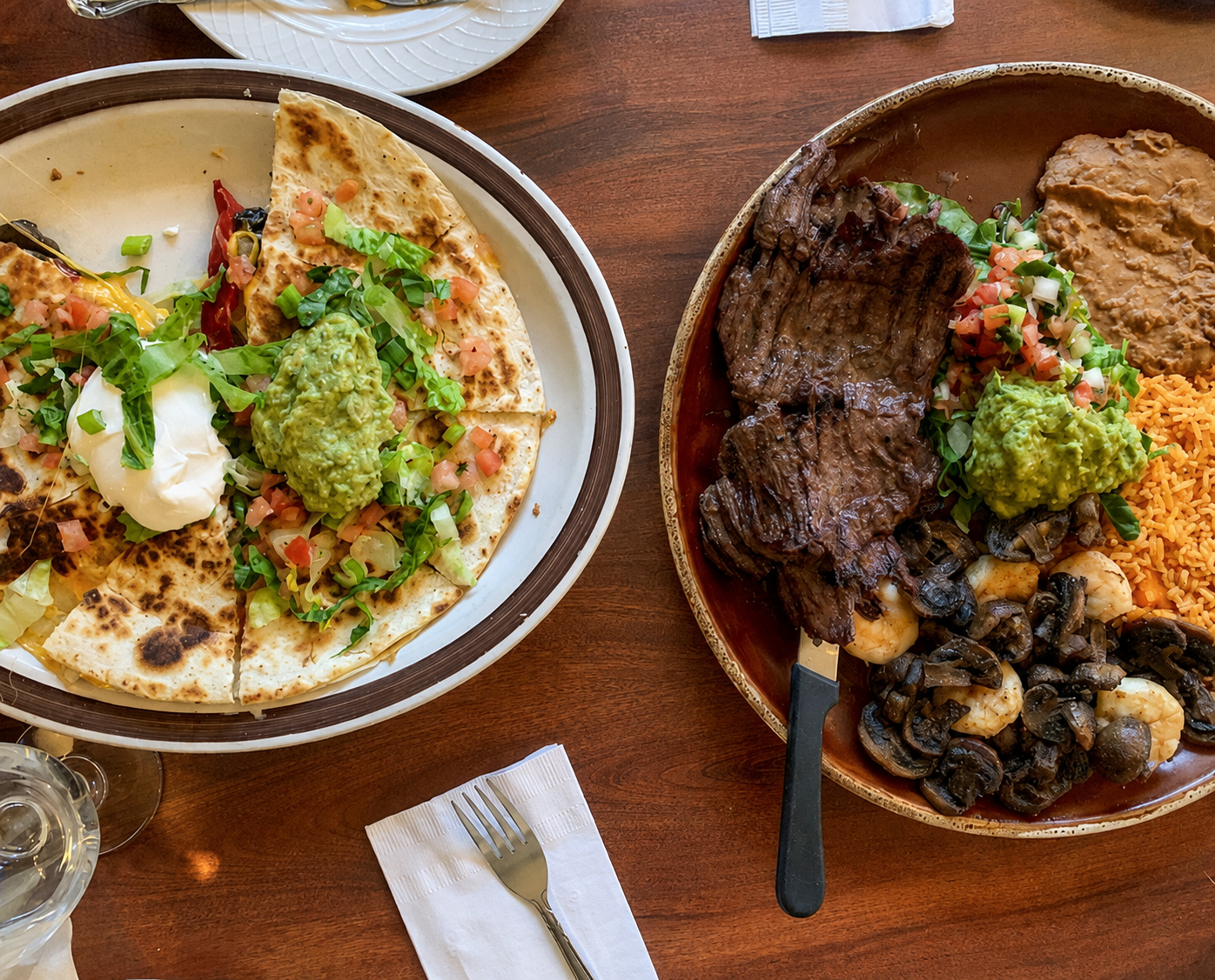 Mexican dishes with quesadillas, steak, rice and guacamole